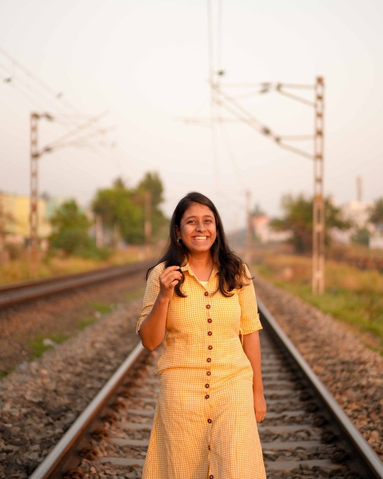 A woman smiles and laughs in a worry-free day look, wearing a cozy one piece linen shirt dress.