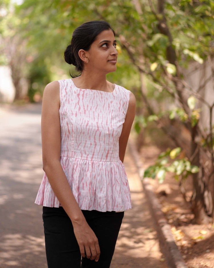 A women wearing pink top in the streets 