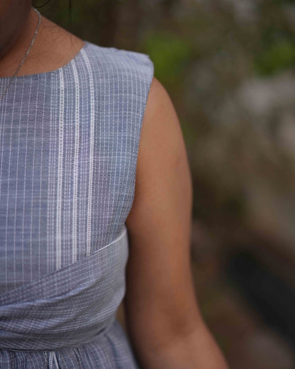Front view close up of the left side of a comfortable blue dress with intricate embroidery design