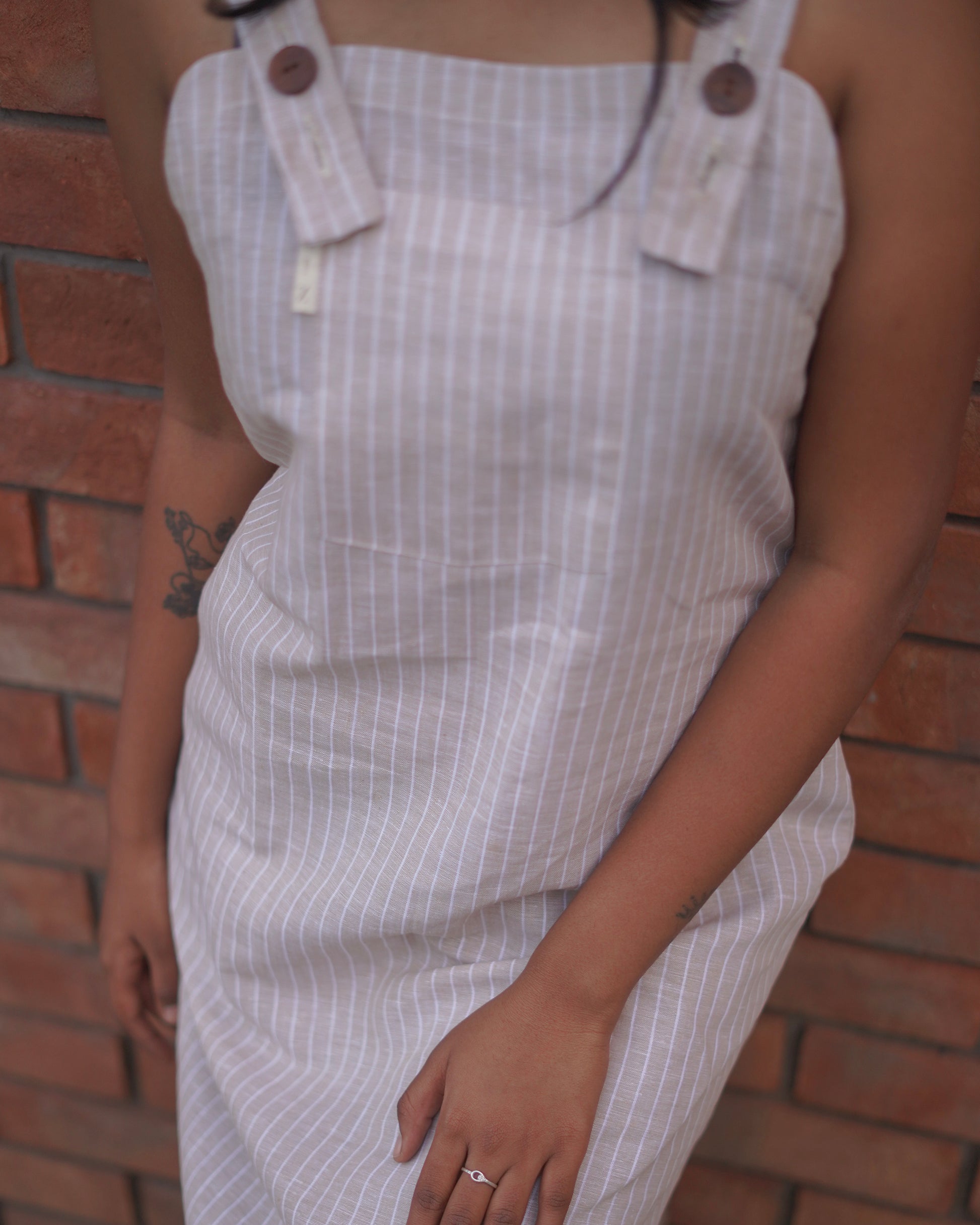 Front close-up of a woman in a Cozy One-Piece Pinafore, highlighting the soft linen cotton blend fabric from below the neck to waist.