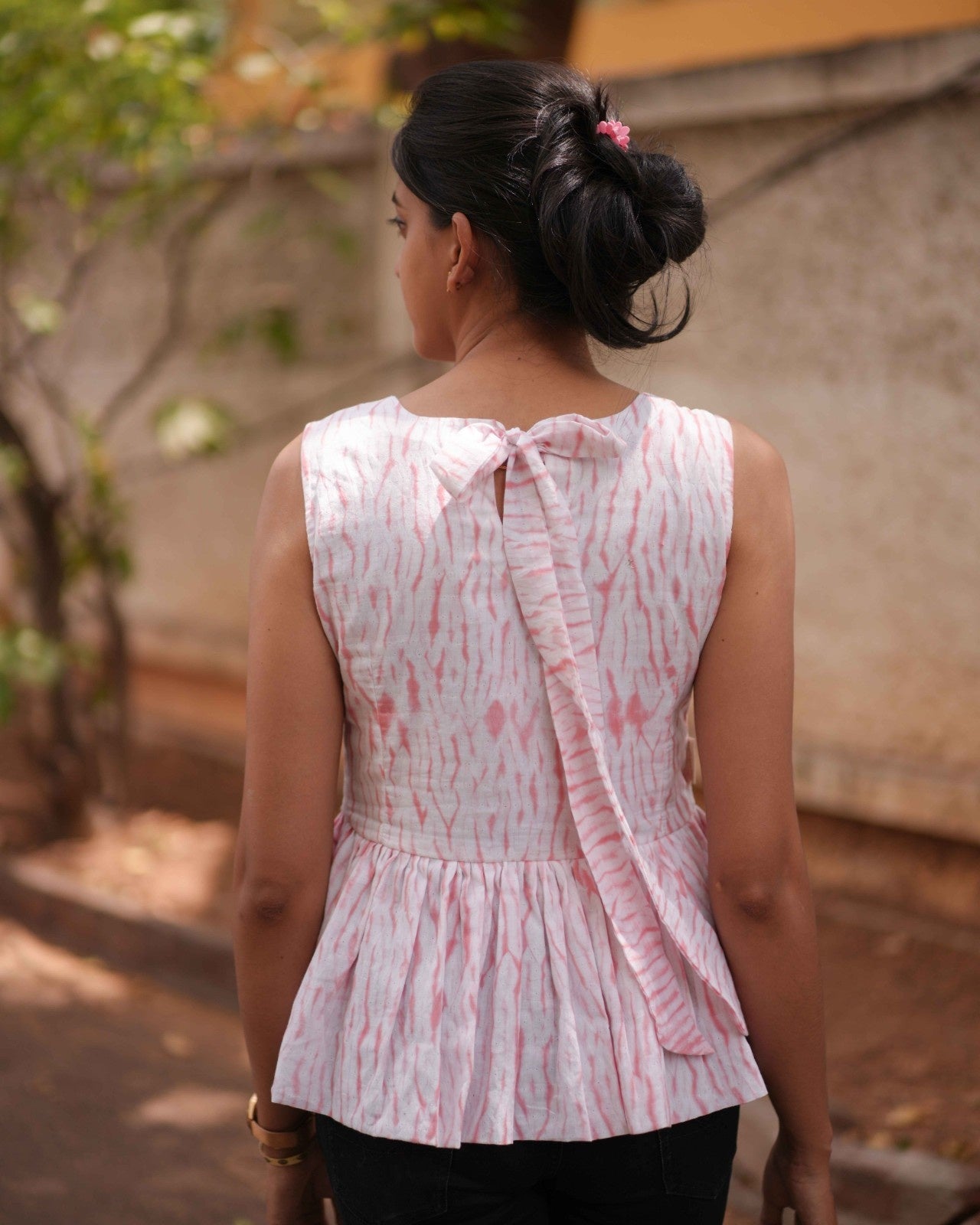 Back torso shot of the Vil Top, highlighting the soft Pink & White Shibori Tie-Dye design and elegant pony tie back detail.