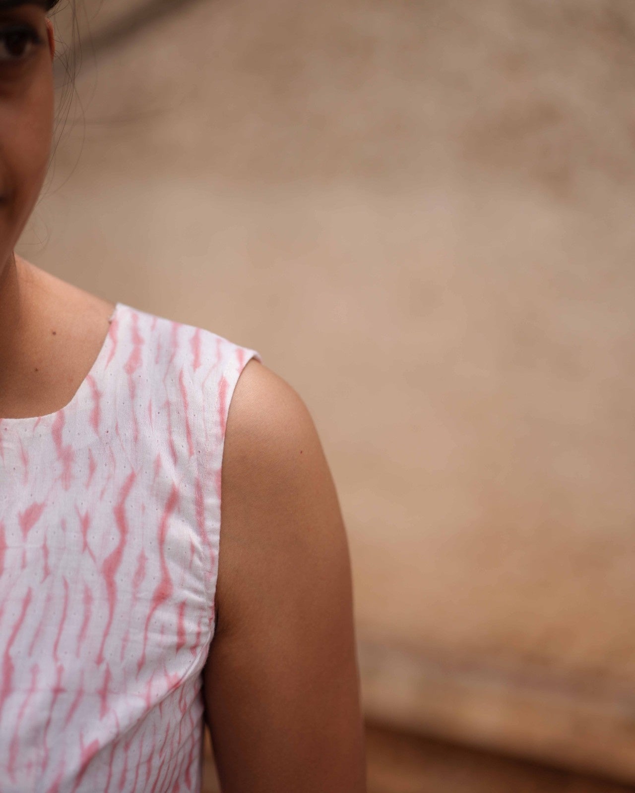 Left shoulder vertical close-up of the Vil Top, highlighting the delicate craftsmanship and flowy, breathable fabric.