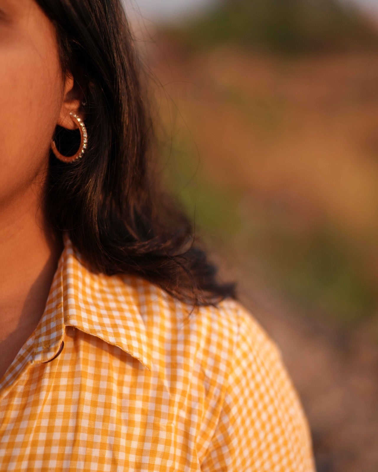 Close-up of the right shoulder fit of a comfortable Cozy One-Piece Linen Shirt Dress, paired with a stylish yellow earring for a confident look.